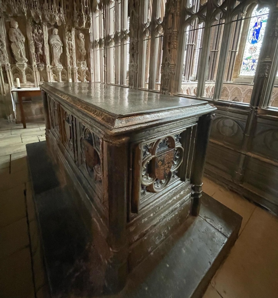 A Sixteenth Century rectangular tomb surrounded by carved walls, sixth some figures carved into the walls.