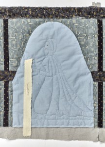 A quilted picture of Jenneke, kneeling under an arch and holding a book. A strip of fabric with text attached falls from the book. 